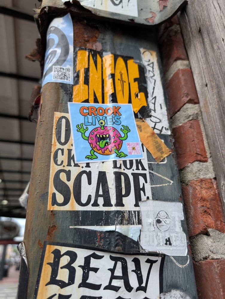 Crook Lives sticker on a city pole