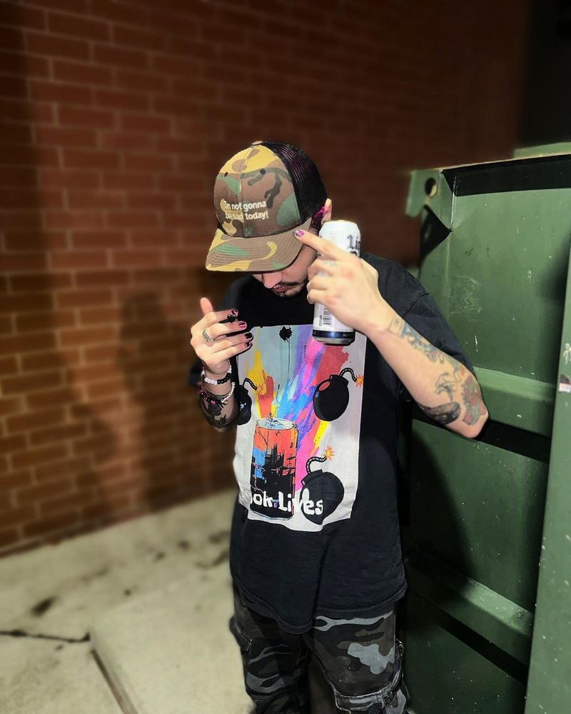 Crook Lives tee worn at night with a spray-can graphic design