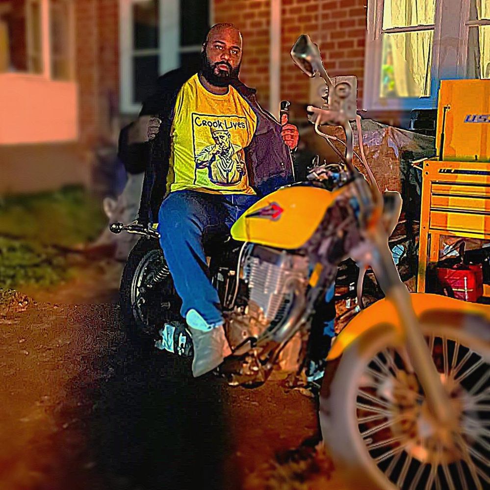 Crook Lives tee worn next to a motorcycle