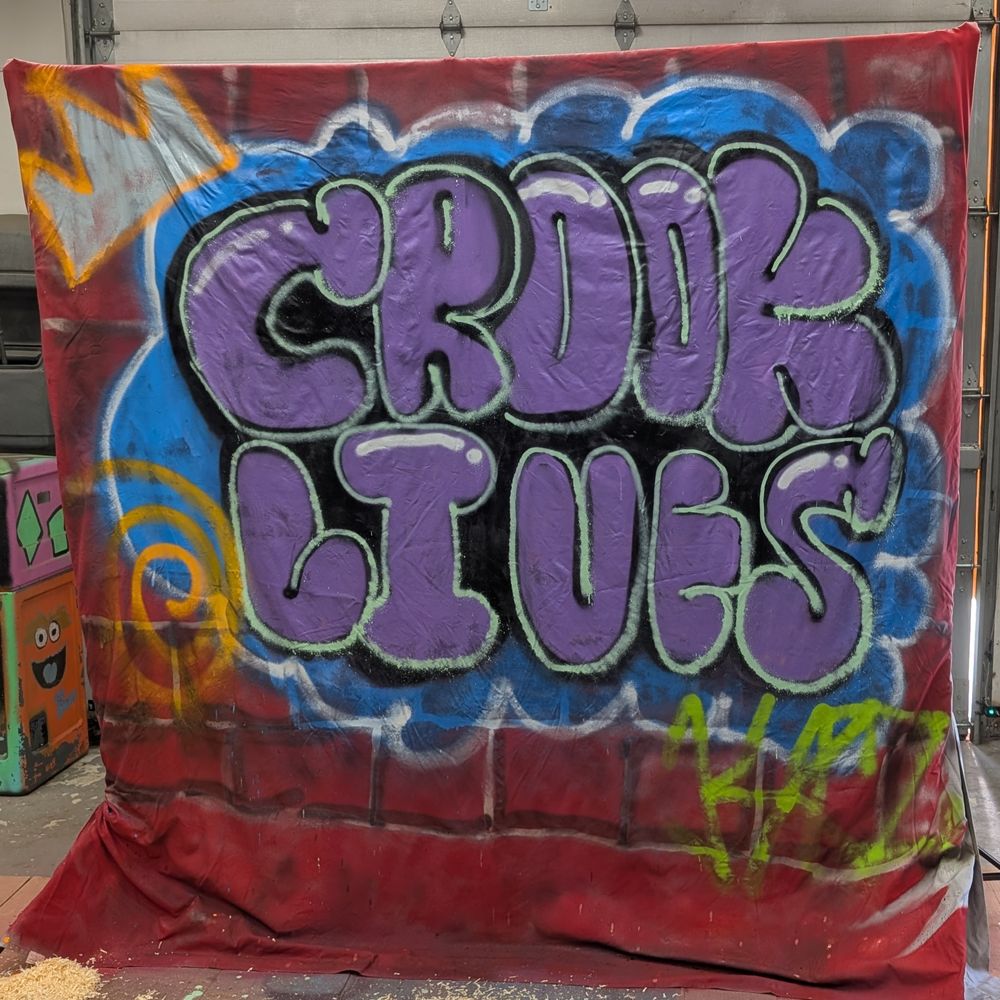 Hand-painted Crook Lives bubble-letter graffiti backdrop